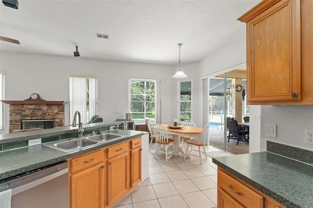a kitchen with granite countertop a sink and a stove