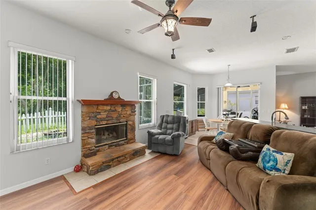 a living room with furniture a fireplace and a window
