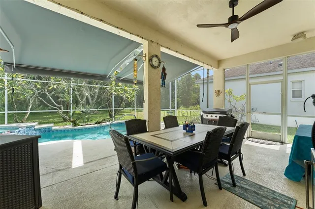 a view of an outdoor dining space with furniture and garden