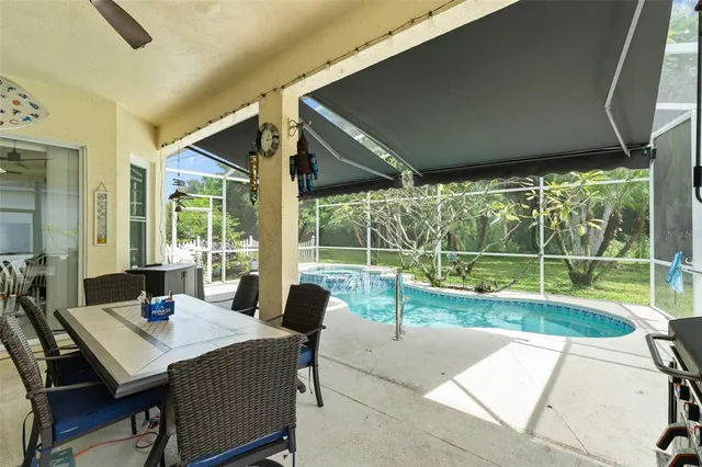 a view of a patio with a table chairs and a backyard
