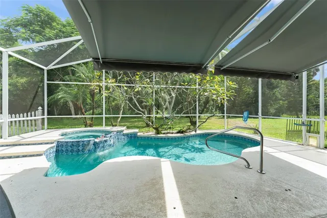 a view of a backyard with swimming pool