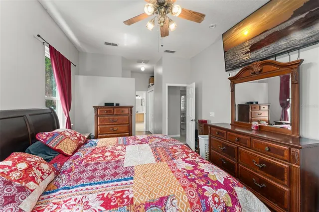 a bedroom with a bed and a dresser in it
