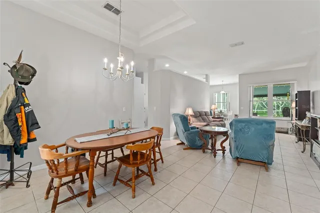 a view of a dining room with furniture and a chandelier