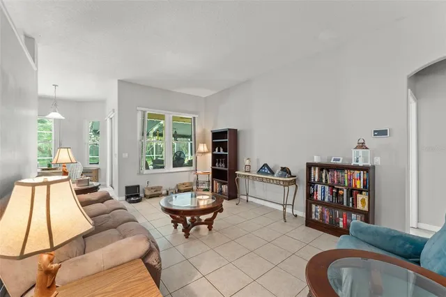 a living room with furniture a window and a flat screen tv