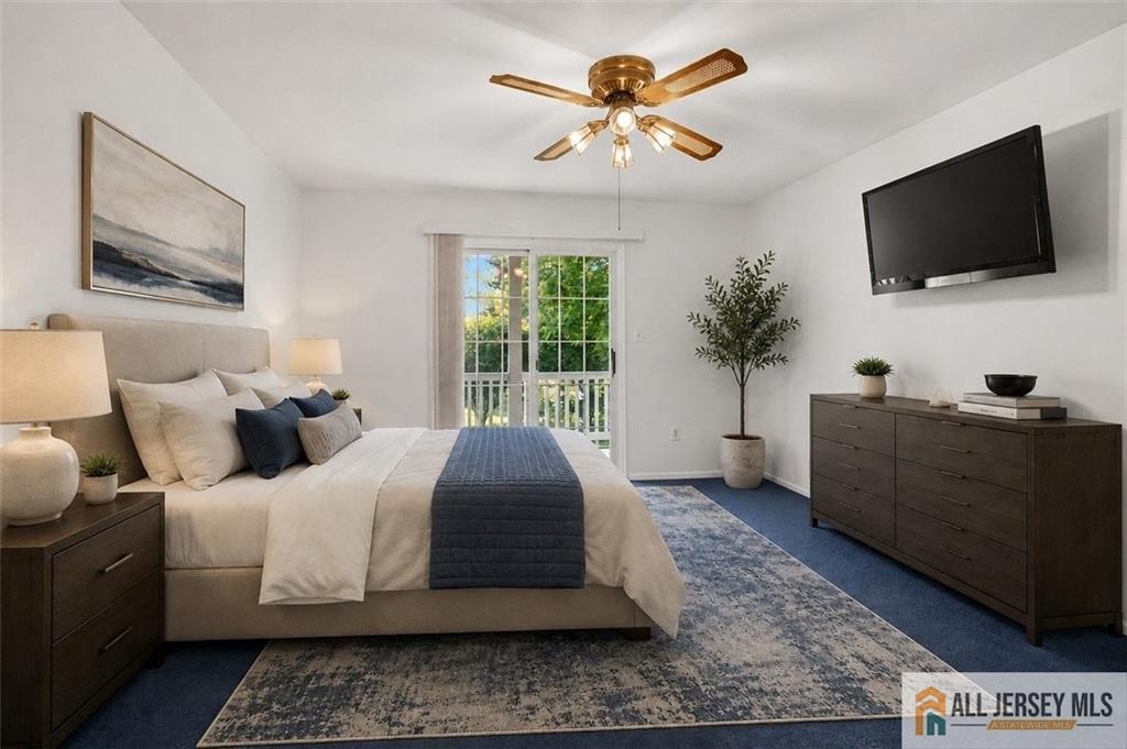 40C Rutland Lane, Unit 40B Monroe Township, NJ 08831 - Photo 21 of 37 a bedroom with a large bed and a flat screen tv