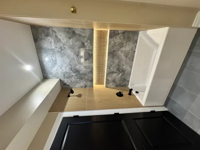 a bathroom with a toilet sink and mirror