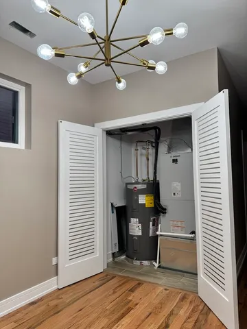 a room with a ceiling fan and hardwood floor