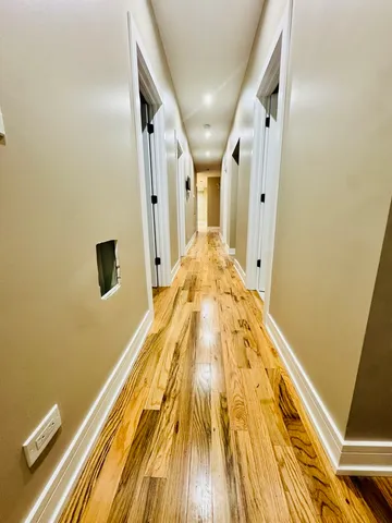 a view of a kitchen with kitchen island and stainless steel appliances