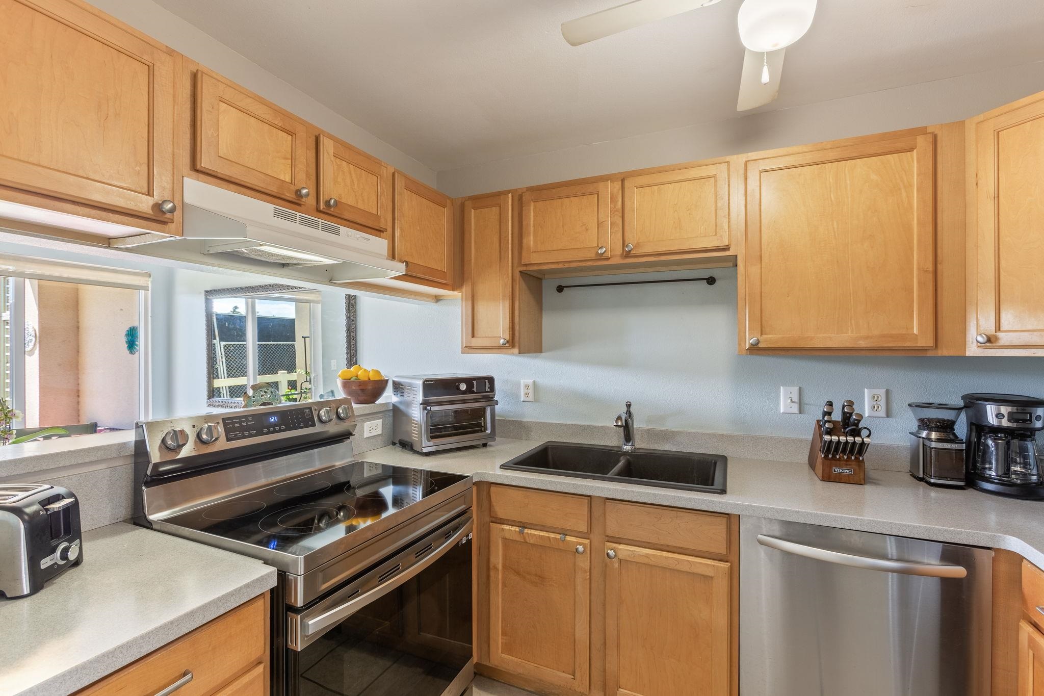 30 Halili Lane, Unit 3D Kihei, HI 96753 - Photo 15 of 46 a kitchen that has a sink and a stove