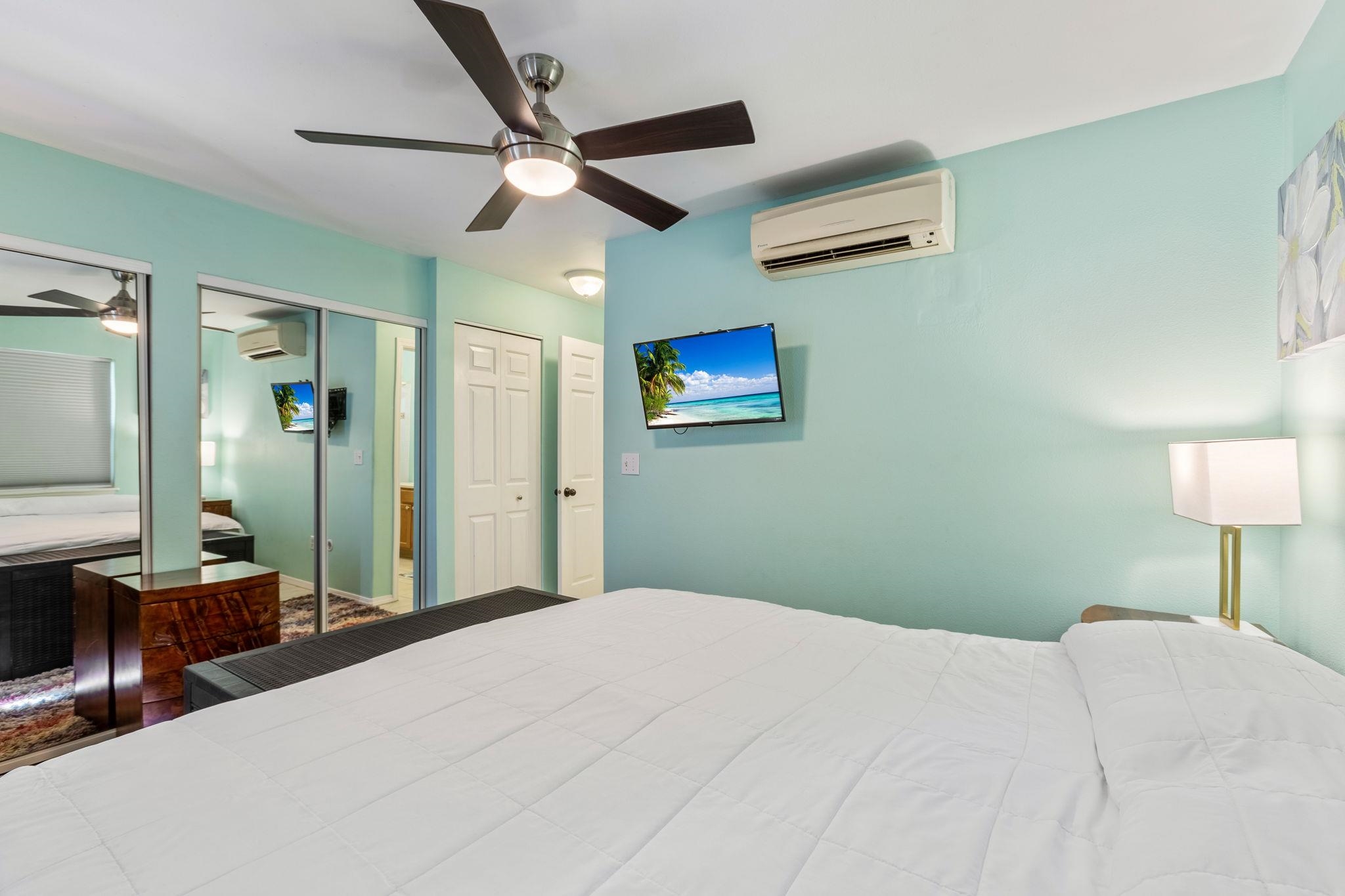 30 Halili Lane, Unit 3D Kihei, HI 96753 - Photo 24 of 46 a bedroom with a bed and a chandelier