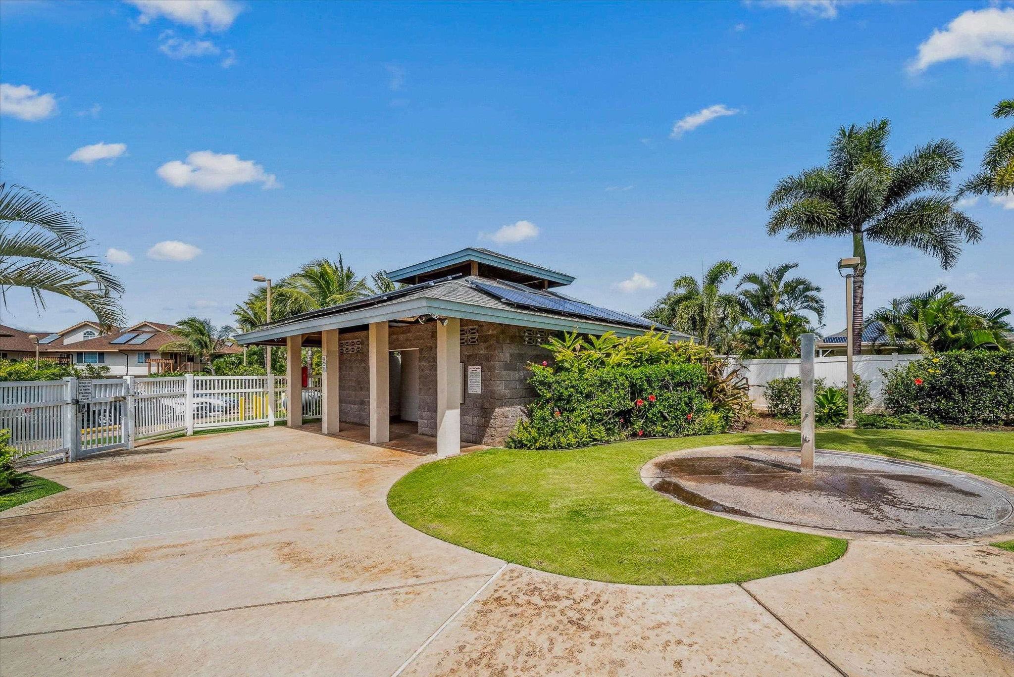 30 Halili Lane, Unit 3D Kihei, HI 96753 - Photo 43 of 46 a view of a house with a yard and potted plants