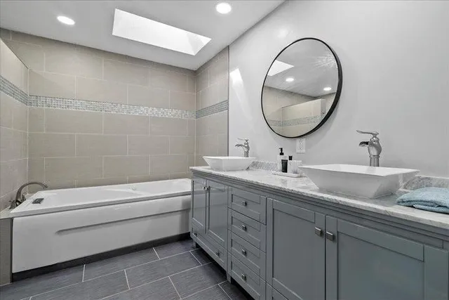 a bathroom with a granite countertop toilet a sink and a mirror