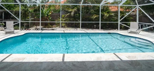a view of a swimming pool with a yard