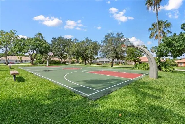 a view of a playground and basketball court