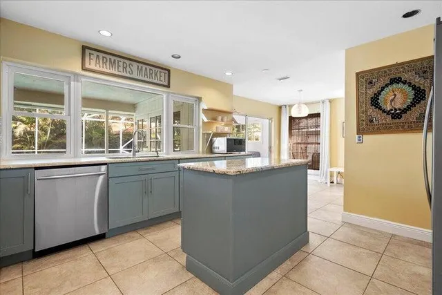 a kitchen with stainless steel appliances granite countertop a refrigerator and a sink