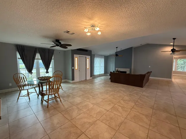 a view of a livingroom with furniture and chandelier