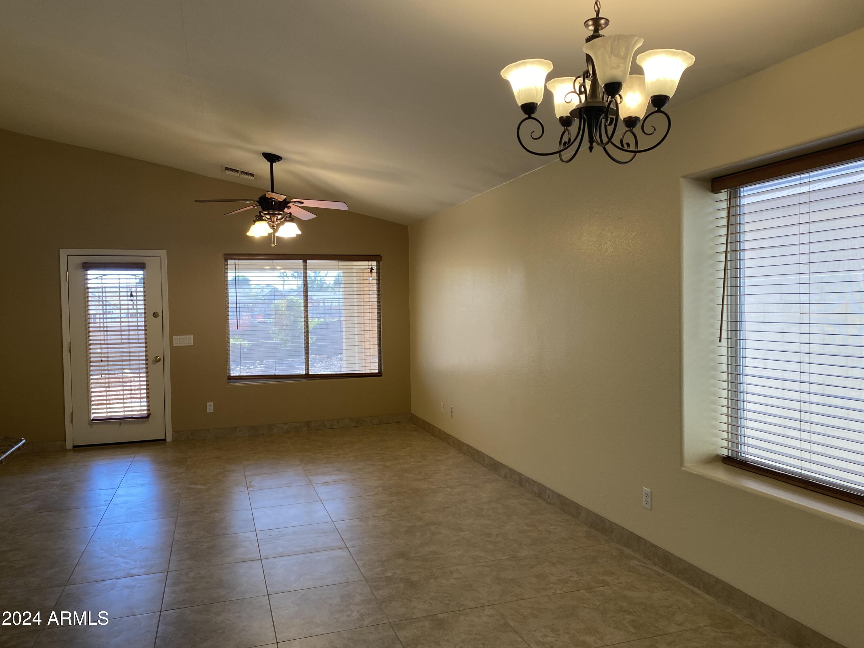 8143 West Marco Polo Road Peoria, AZ 85382 - Photo 12 of 29 a view of an empty room with a window and wooden floor