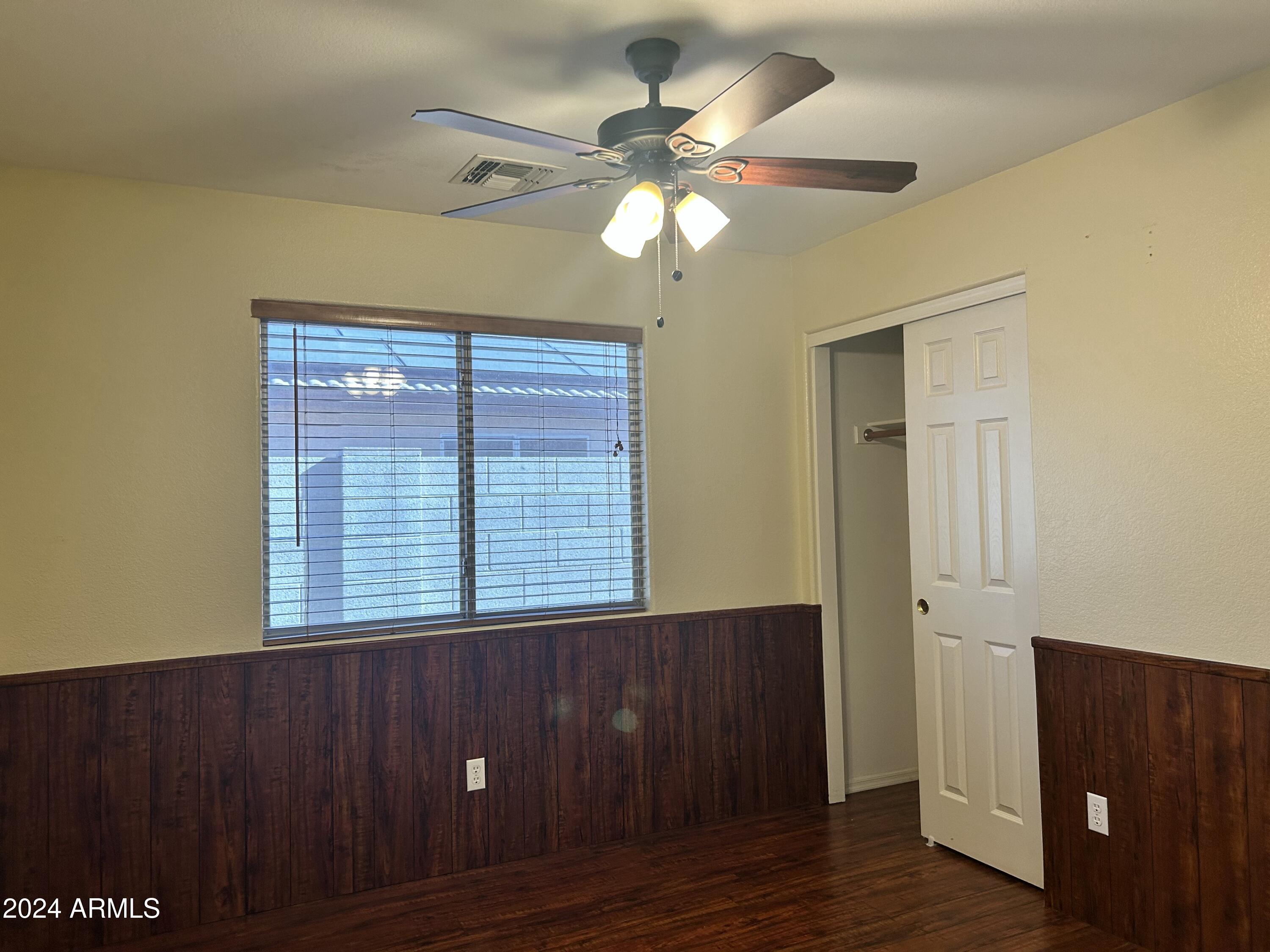 8143 West Marco Polo Road Peoria, AZ 85382 - Photo 21 of 29 a view of an empty room with wooden floor and a window