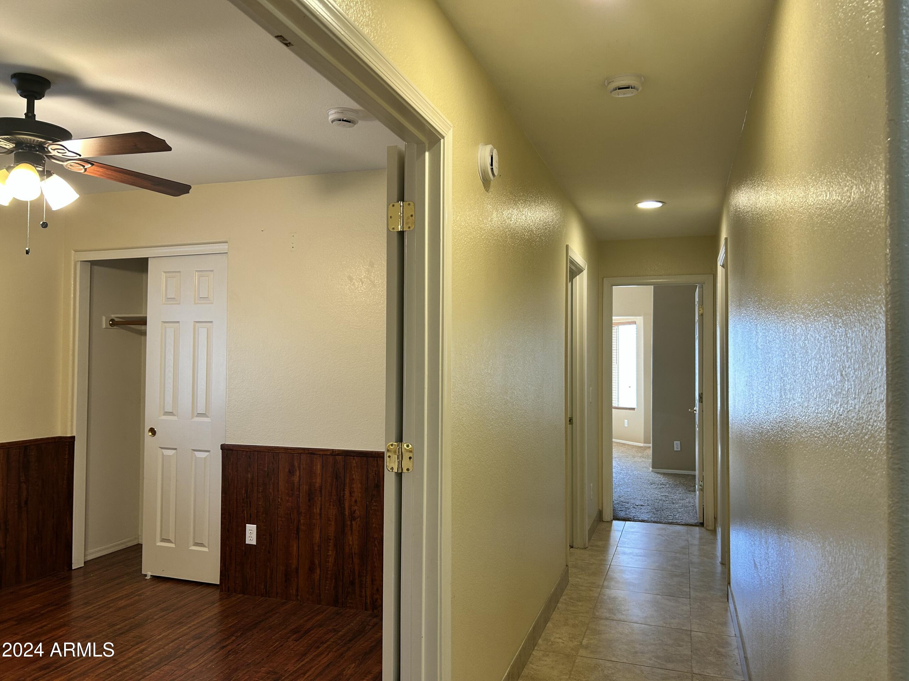 8143 West Marco Polo Road Peoria, AZ 85382 - Photo 22 of 29 a view of hallway with livingroom and wooden floor