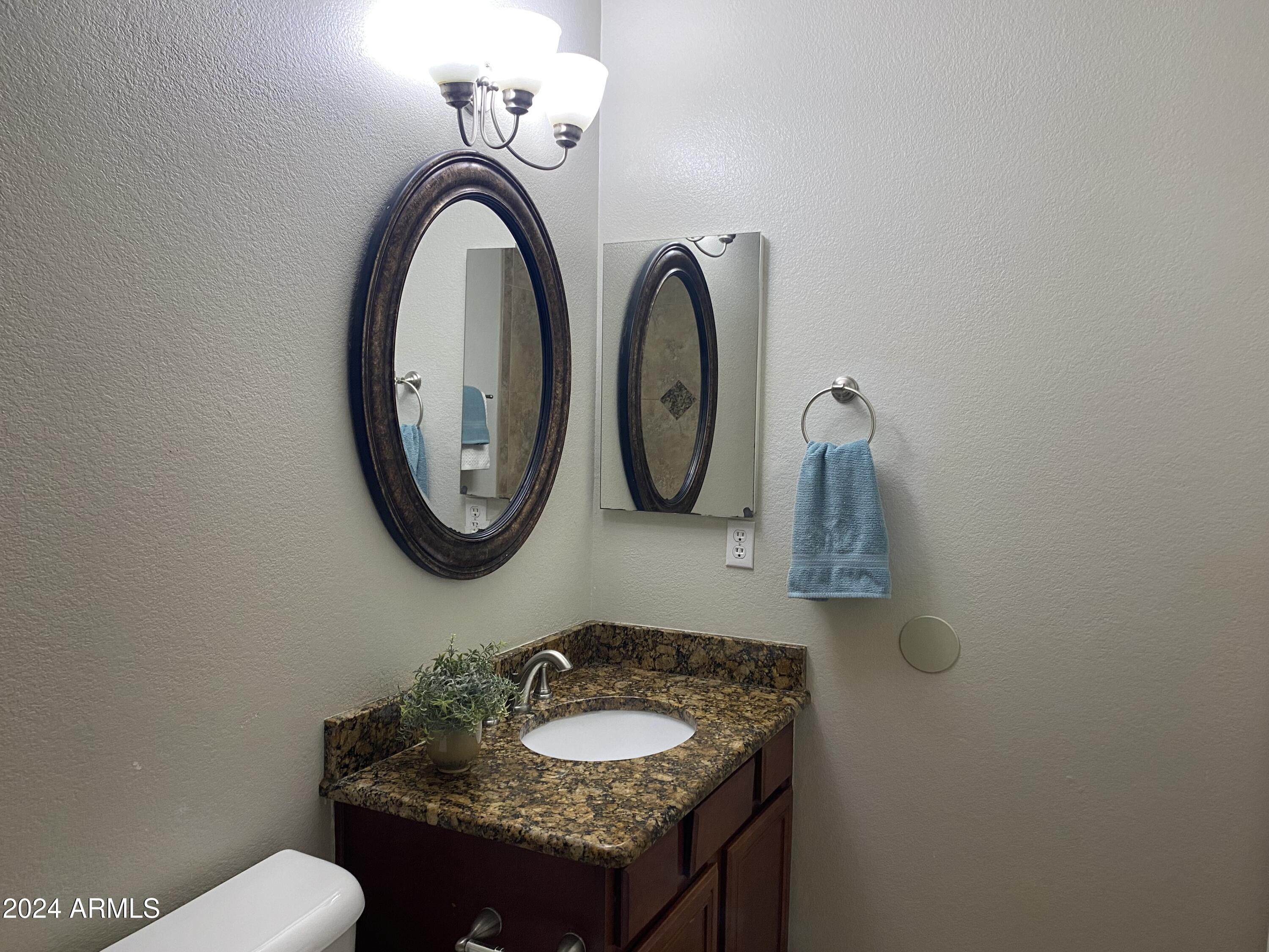 8143 West Marco Polo Road Peoria, AZ 85382 - Photo 24 of 29 a bathroom with a granite countertop sink and a mirror