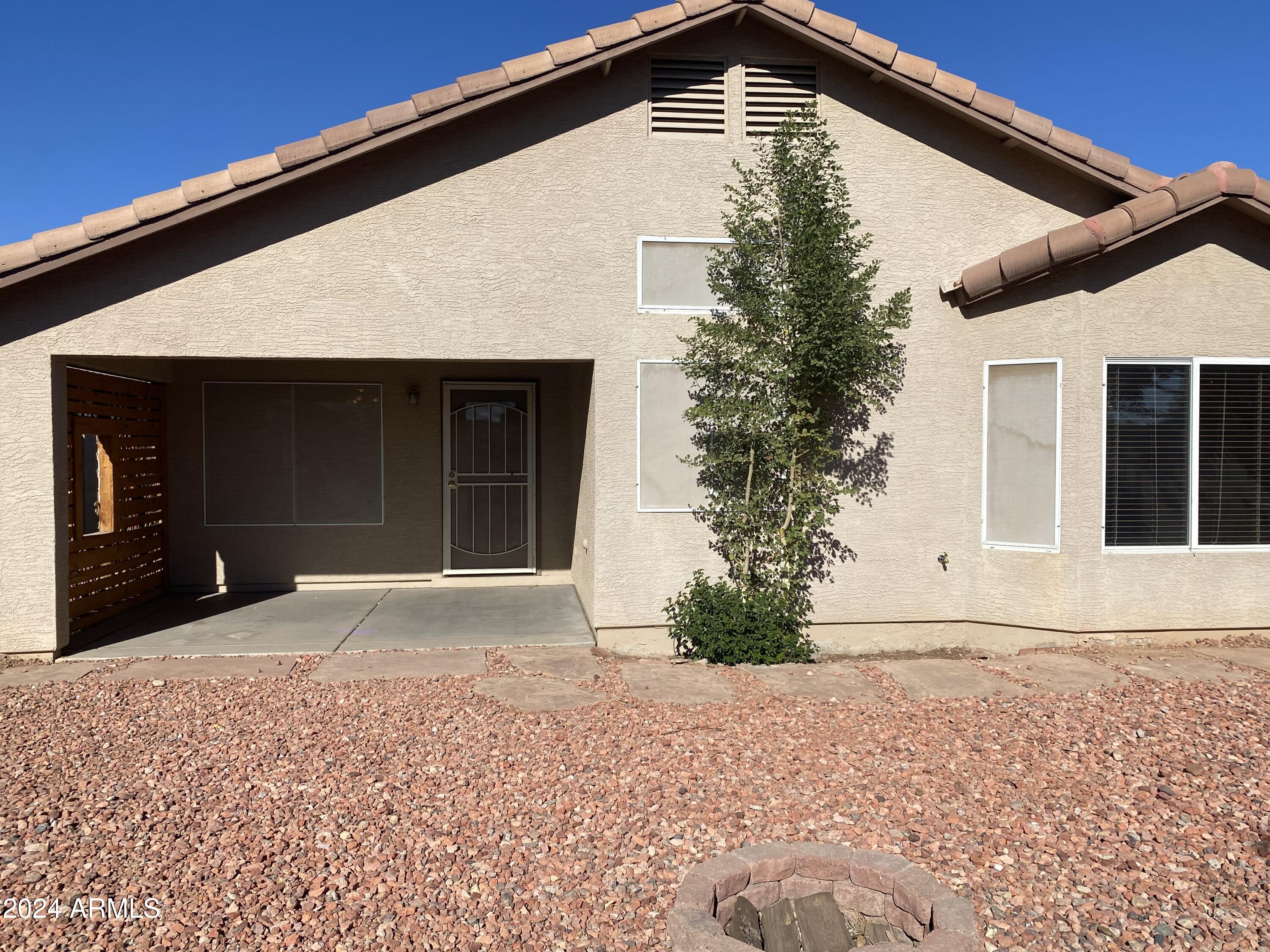 8143 West Marco Polo Road Peoria, AZ 85382 - Photo 26 of 29 a front view of a house with a yard and garage