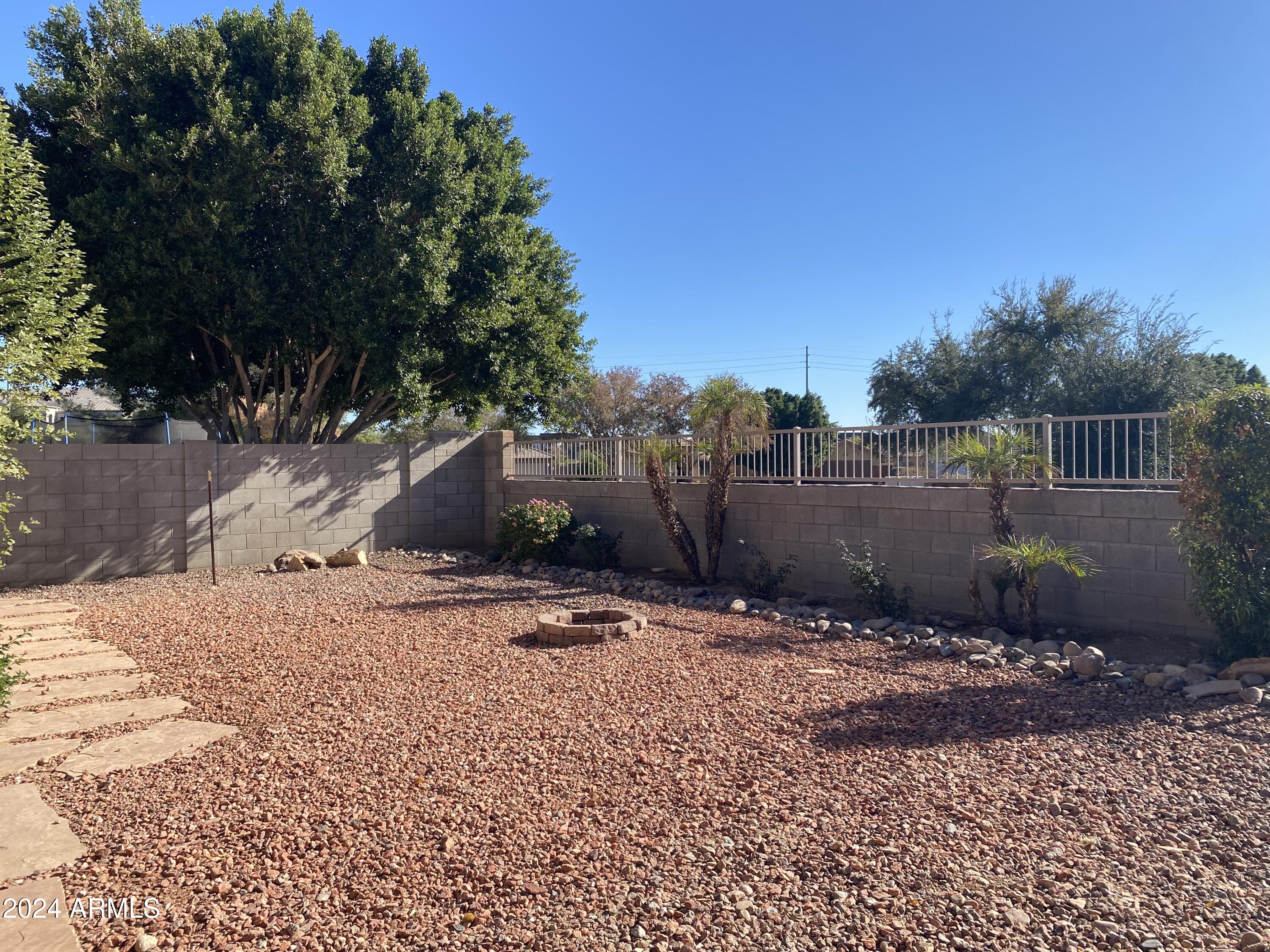8143 West Marco Polo Road Peoria, AZ 85382 - Photo 27 of 29 a backyard of a house with lots of green space
