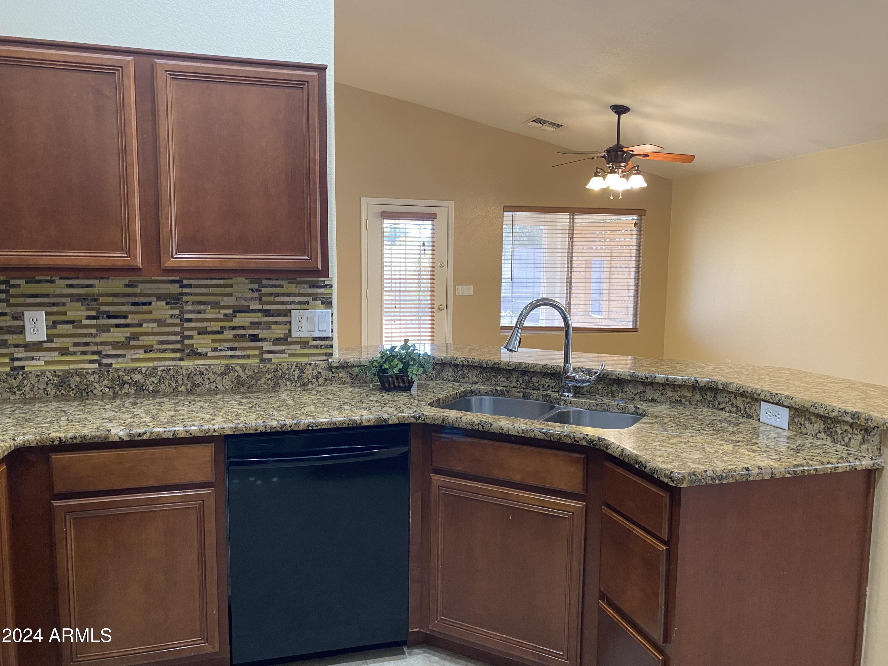 8143 West Marco Polo Road Peoria, AZ 85382 - Photo 5 of 29 a kitchen with granite countertop a sink and cabinets
