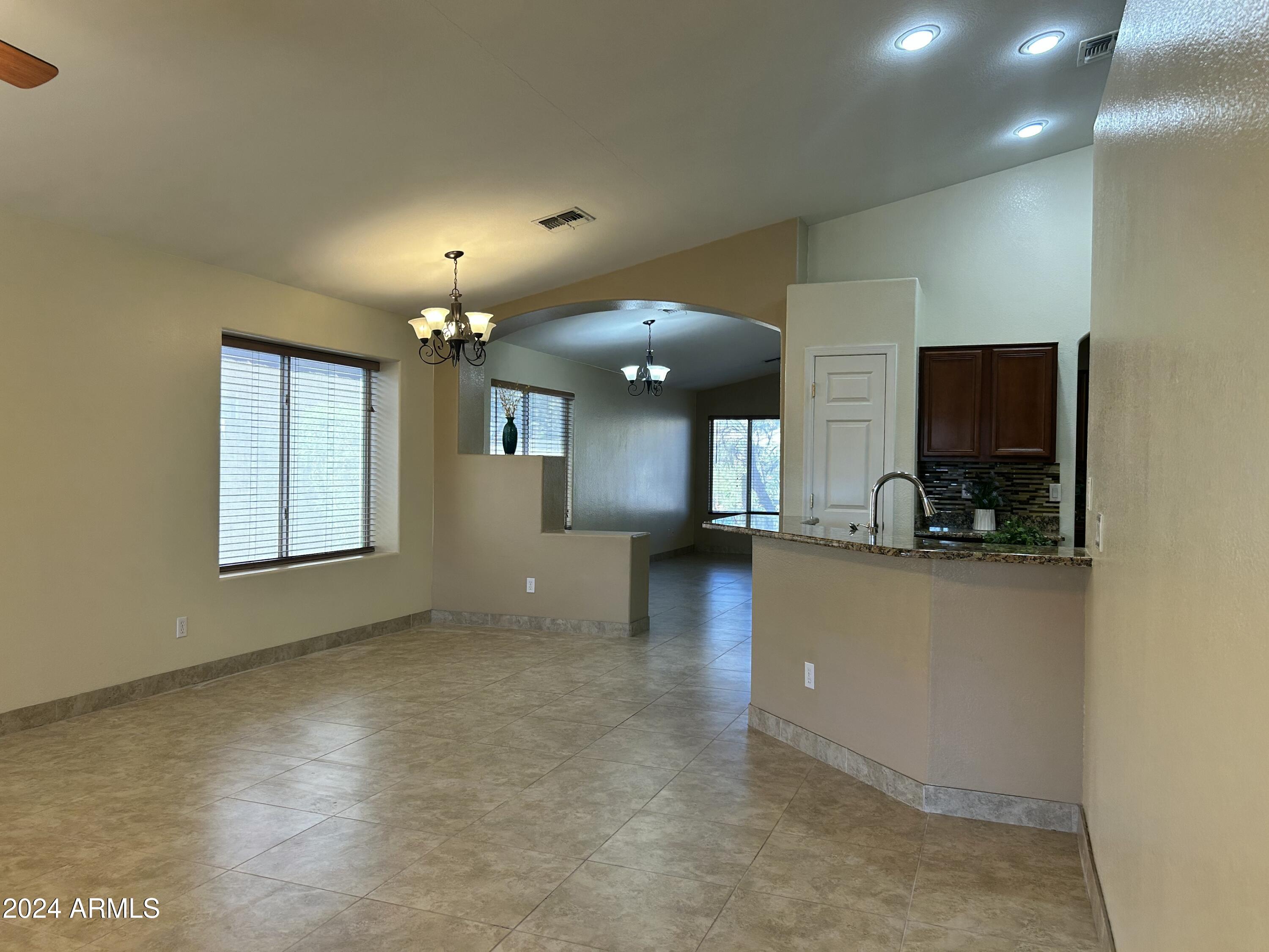 8143 West Marco Polo Road Peoria, AZ 85382 - Photo 10 of 29 a view of a living room a ceiling fan and a flat screen tv