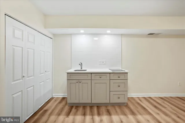 a spacious bathroom with a sink and a mirror