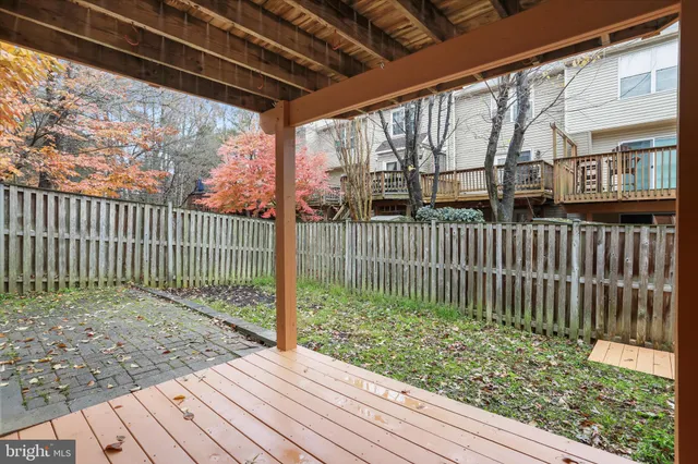 a view of a porch with a floor to ceiling window and wooden fence