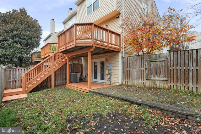 a view of a house with wooden fence