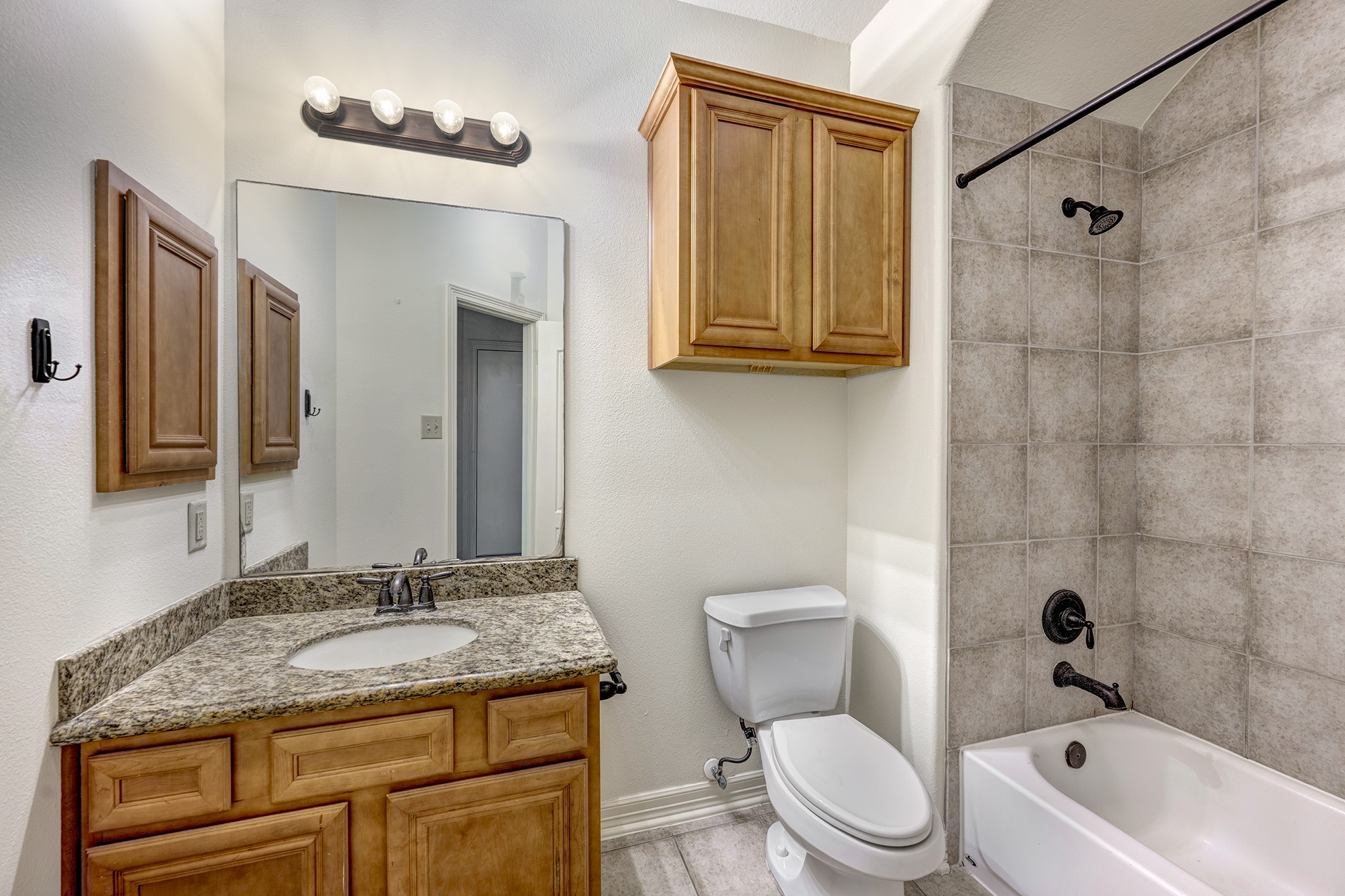 10348 Stone Gate Drive Conroe, TX 77385 - Photo 15 of 20 a bathroom with a granite countertop sink toilet and shower