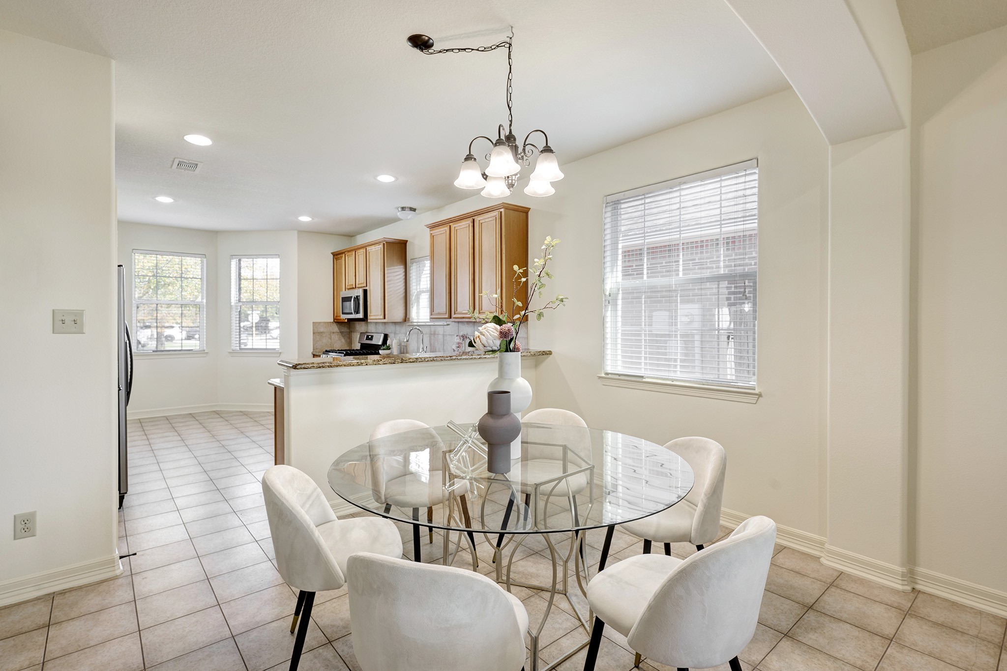 10348 Stone Gate Drive Conroe, TX 77385 - Photo 4 of 20 a view of a dining room with furniture and a chandelier