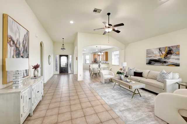 a living room with furniture and a chandelier