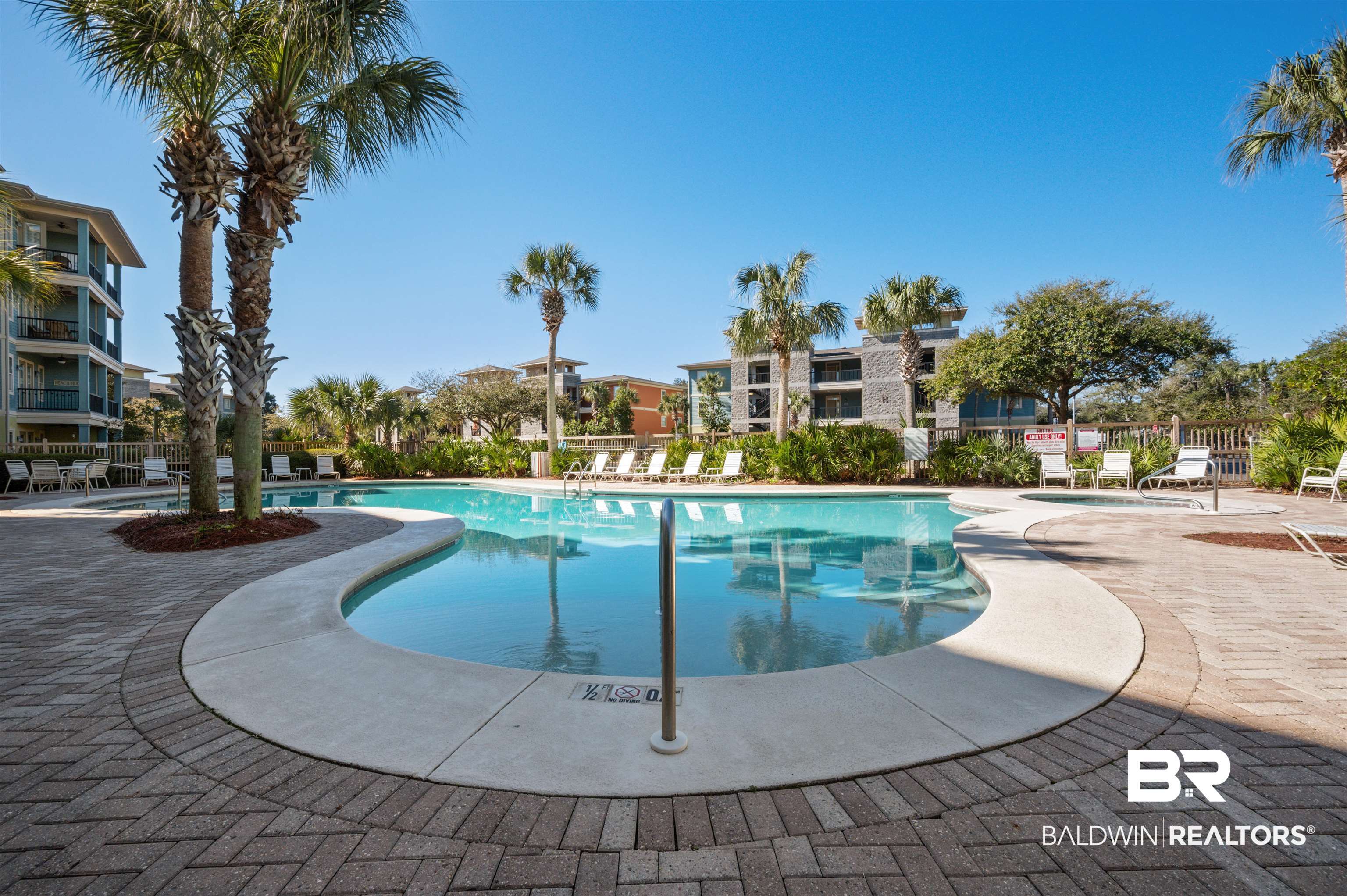 1430 Regency Road, Unit B202 Gulf Shores, AL 36542 - Photo 32 of 33 Community pool featuring a patio area and fence