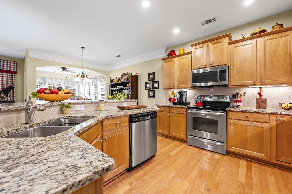 1081 Spring Station Road Greensboro, GA 30642 - Photo 11 of 35 a kitchen with stainless steel appliances granite countertop a sink stove and refrigerator