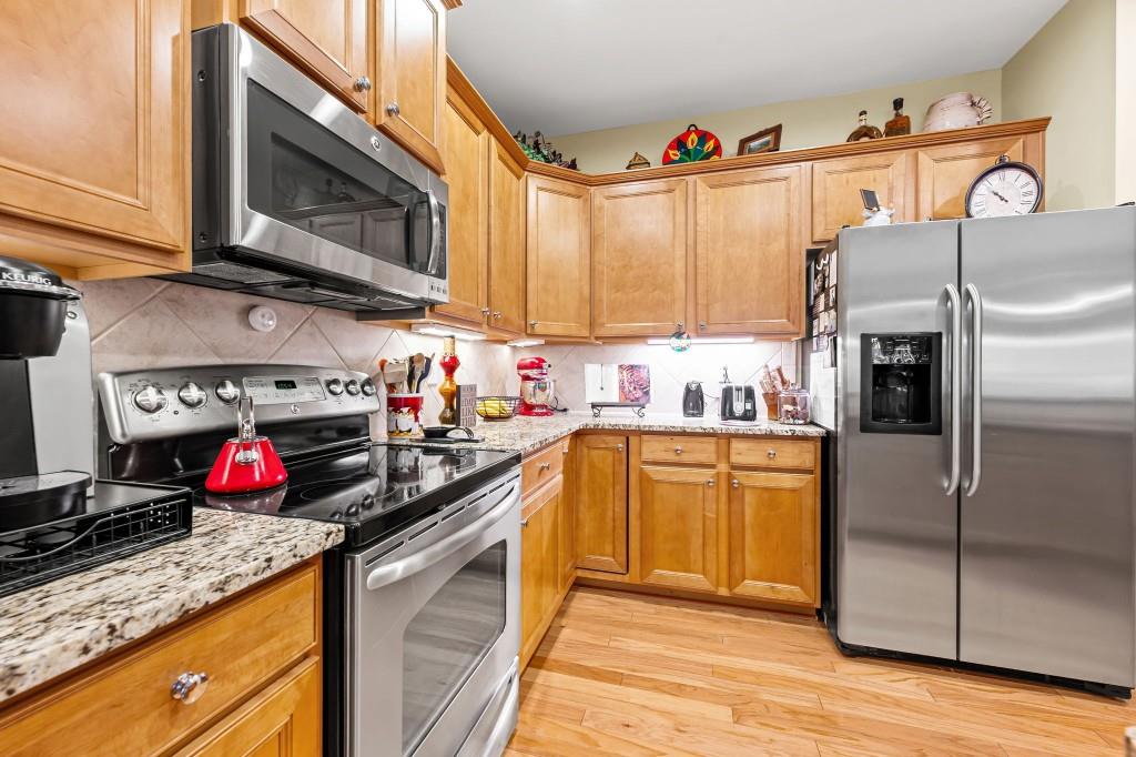 1081 Spring Station Road Greensboro, GA 30642 - Photo 12 of 35 a kitchen with granite countertop a sink stainless steel appliances and cabinets