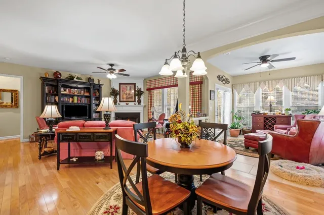 a view of a dining room with furniture and chandelier