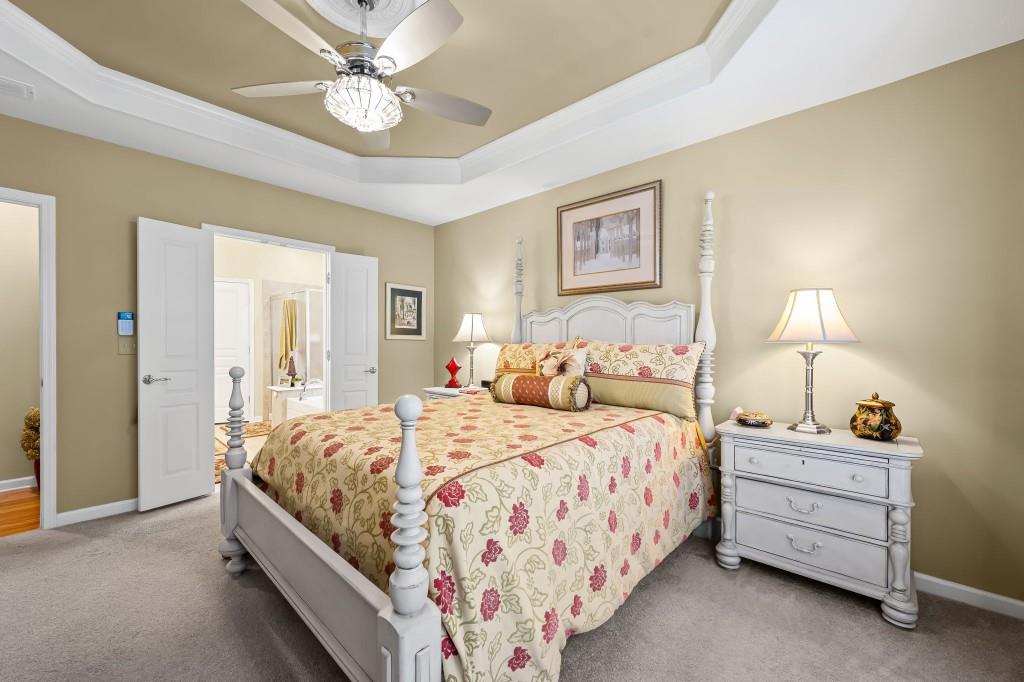 1081 Spring Station Road Greensboro, GA 30642 - Photo 20 of 35 a bedroom with a bed and a chandelier