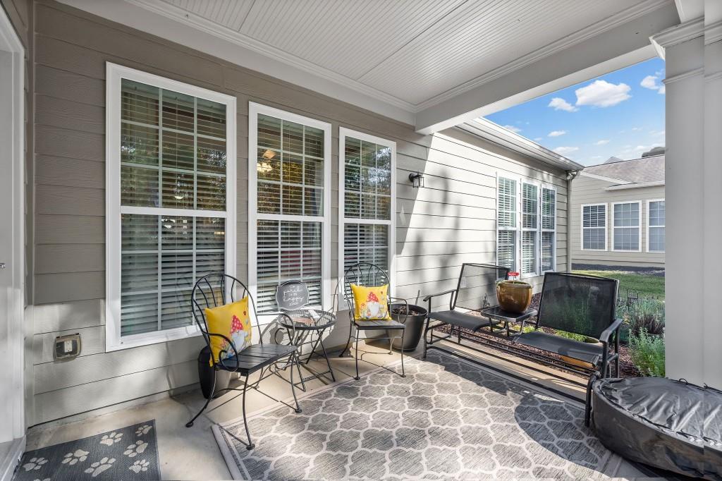 1081 Spring Station Road Greensboro, GA 30642 - Photo 31 of 35 a living room filled with furniture hardwood floor and a floor to ceiling window