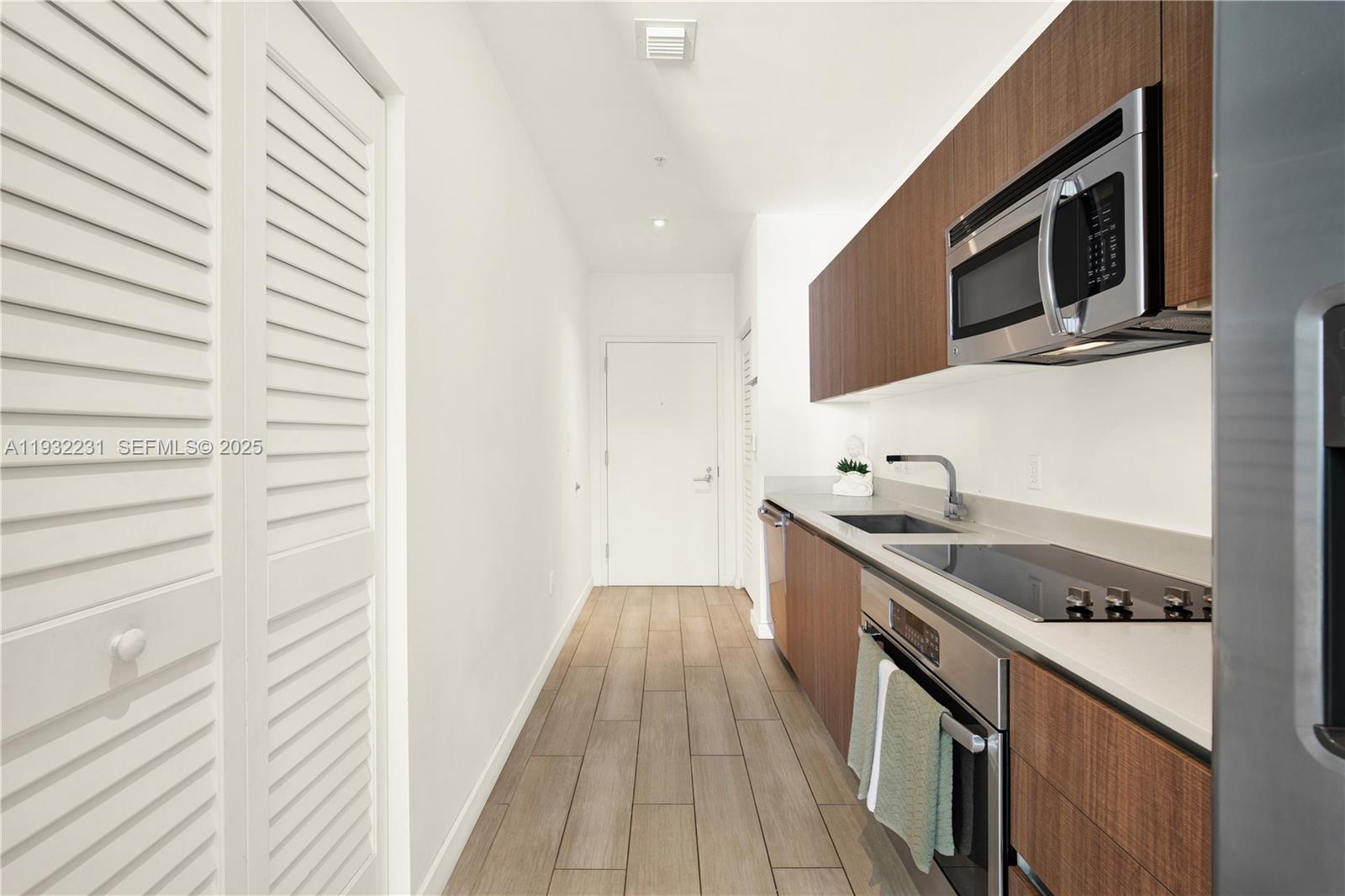 1600 Southwest 1st Avenue, Unit 804 Miami, FL 33129 - Photo 15 of 31 a kitchen with stainless steel appliances granite countertop a sink and a stove