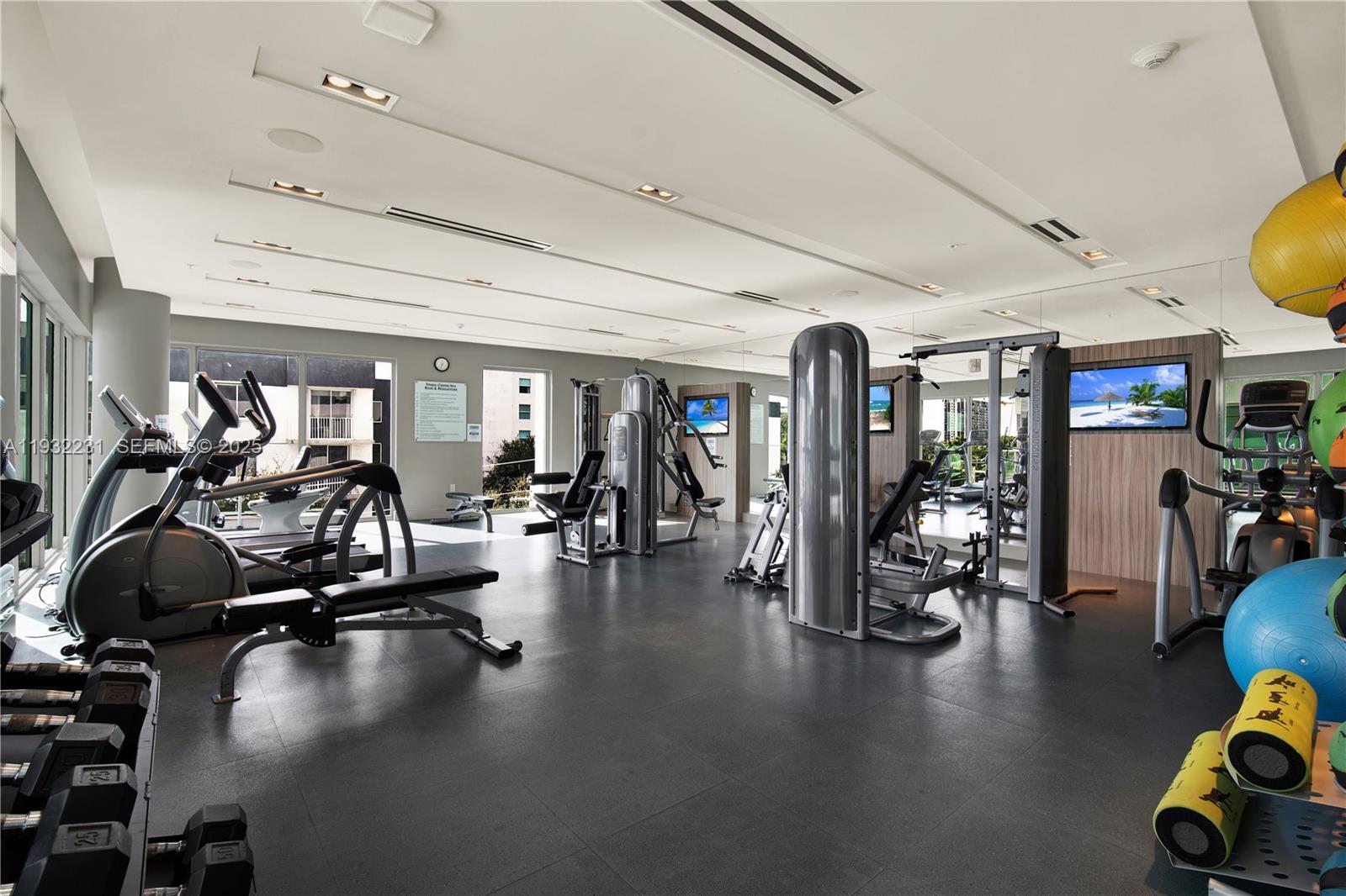 1600 Southwest 1st Avenue, Unit 804 Miami, FL 33129 - Photo 20 of 31 a gym room with lots of gym equipment