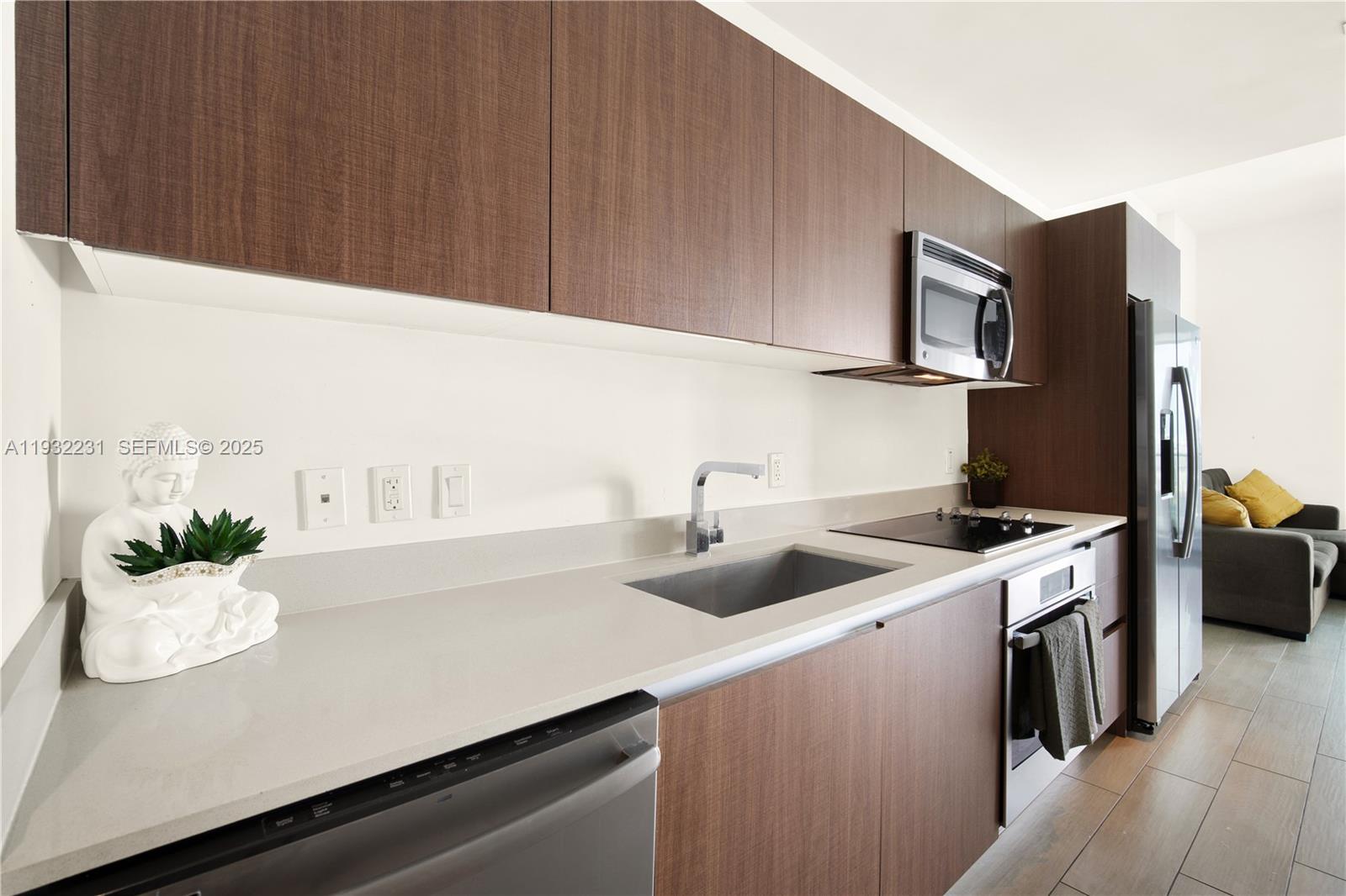1600 Southwest 1st Avenue, Unit 804 Miami, FL 33129 - Photo 3 of 31 a kitchen with a sink and cabinets