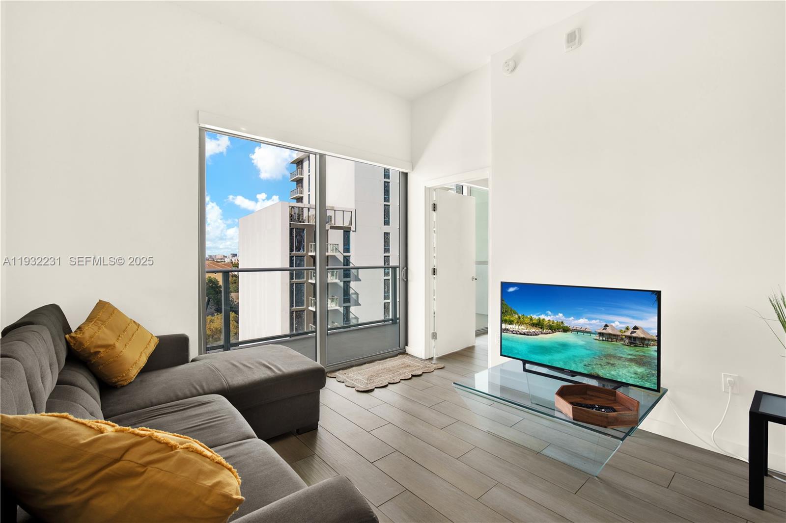 1600 Southwest 1st Avenue, Unit 804 Miami, FL 33129 - Photo 5 of 31 a living room with furniture and a floor to ceiling window
