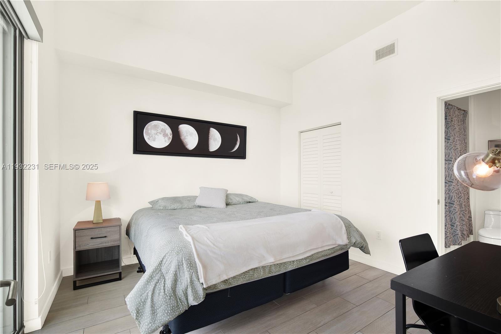 1600 Southwest 1st Avenue, Unit 804 Miami, FL 33129 - Photo 9 of 31 a bedroom with a bed and a desk