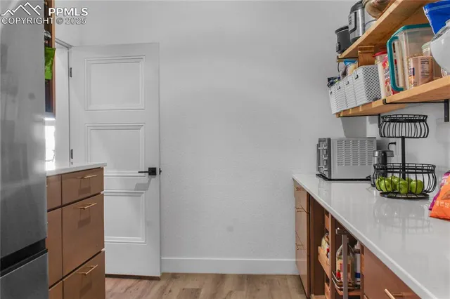 a kitchen with a refrigerator and cabinets