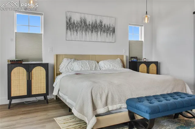 a bedroom with a bed and wall painting