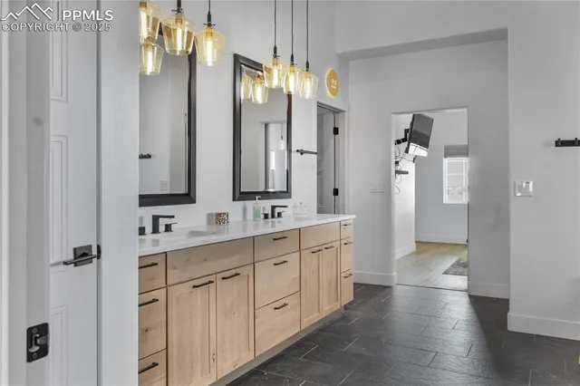 a bathroom with a double vanity sink a mirror and a shower