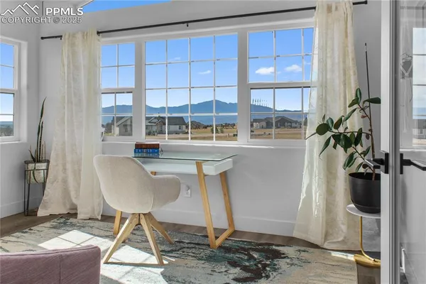 a dining room with table chairs and entryway