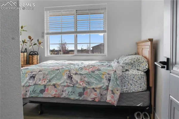 a bed sitting in a bedroom next to a window